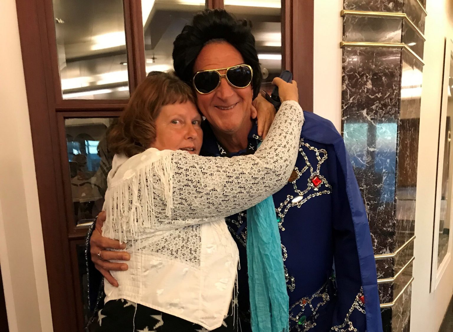 A person and elvis impersonater posing for a picture