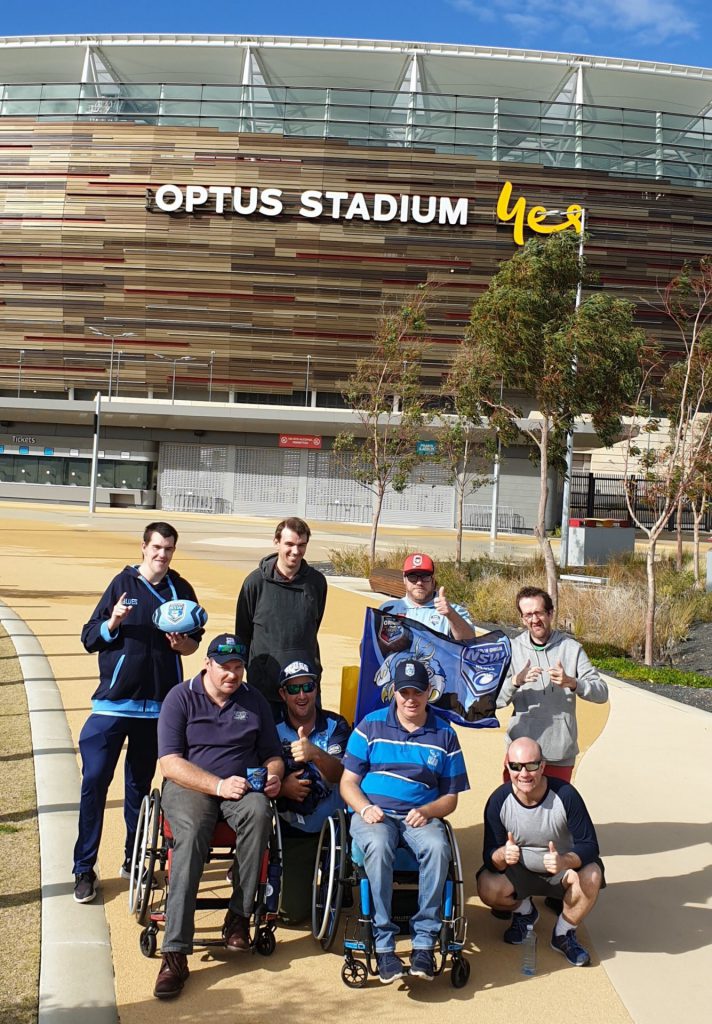 Group of people posing in front of Optus Stadium