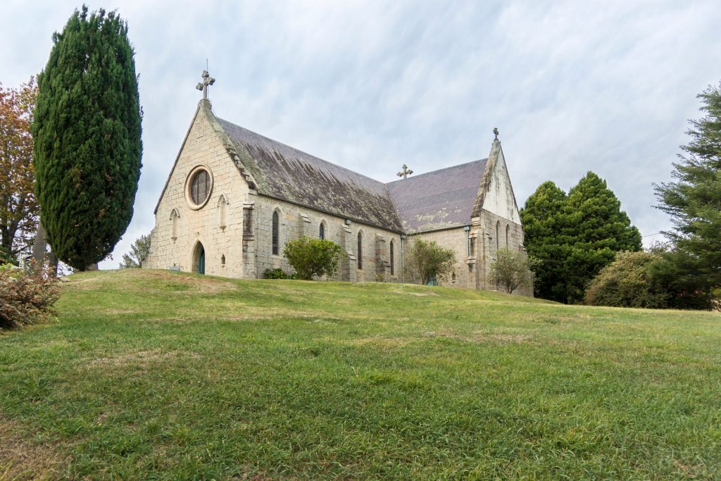 A church with a large lawn in front of it