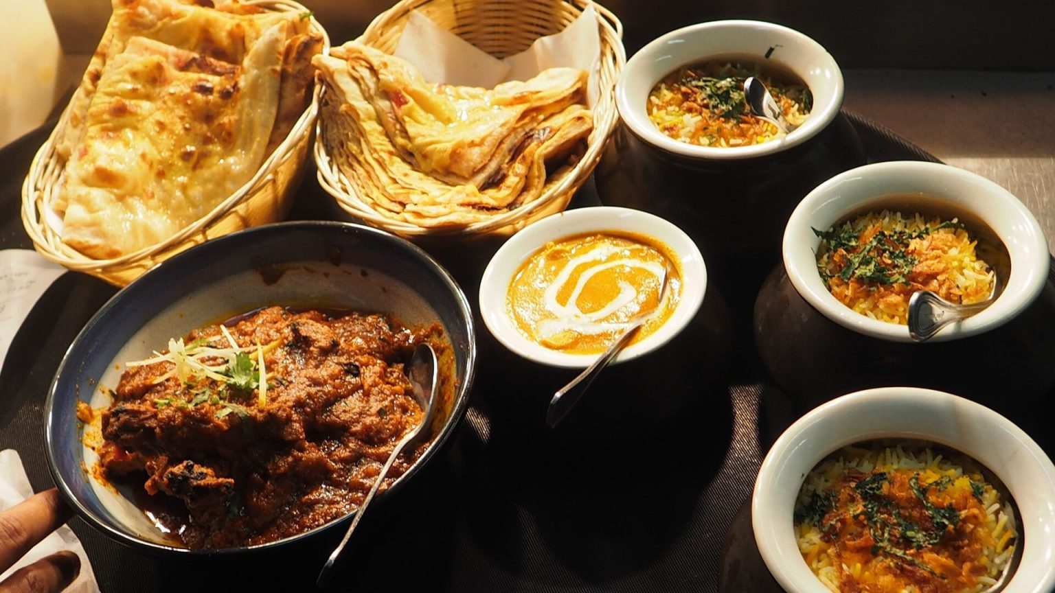 Assorted Indian food on wooden table